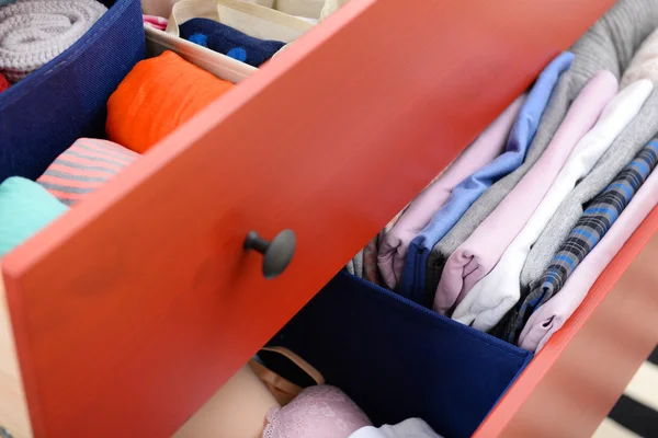 Folded clothes in chest — Stock Photo, Image