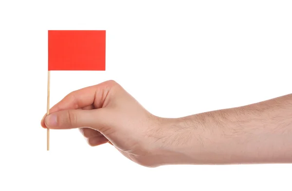 Mão segurando bandeira vermelha — Fotografia de Stock