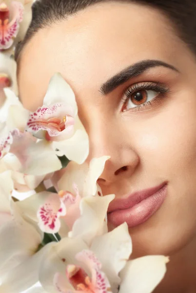 Pretty woman with orchids — Stock Photo, Image