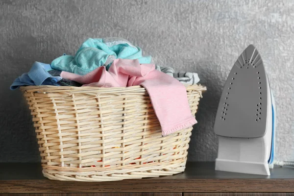 Clothes in wicker basket — Stock Photo, Image