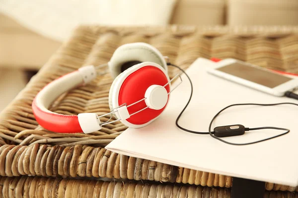 New headphones on wicker trunk — Stock Photo, Image