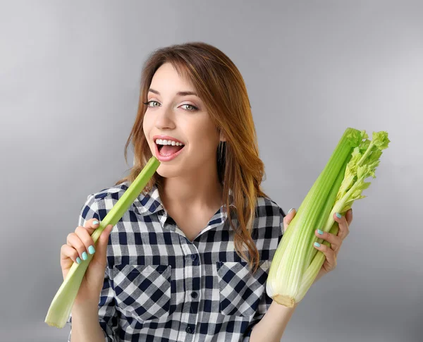 Beautiful girl eating celery — Stock Photo, Image