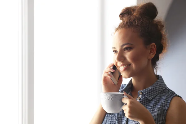 African American girl drinking coffee — Stock Photo, Image