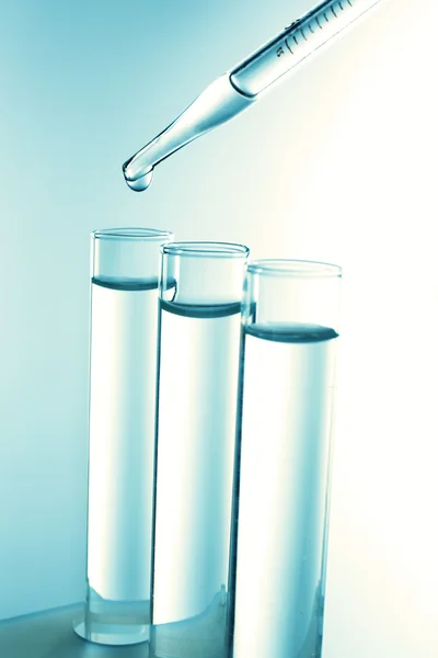 Pipette dropping blue sample — Stock Photo, Image