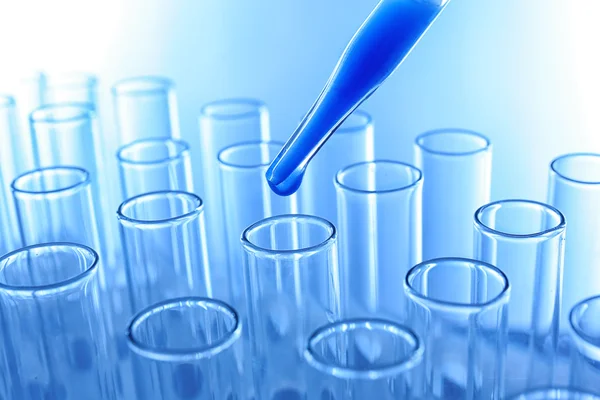 Pipette dropping blue sample — Stock Photo, Image