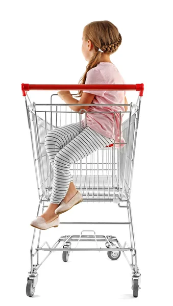Cute girl sitting in shopping cart — Stock Photo, Image