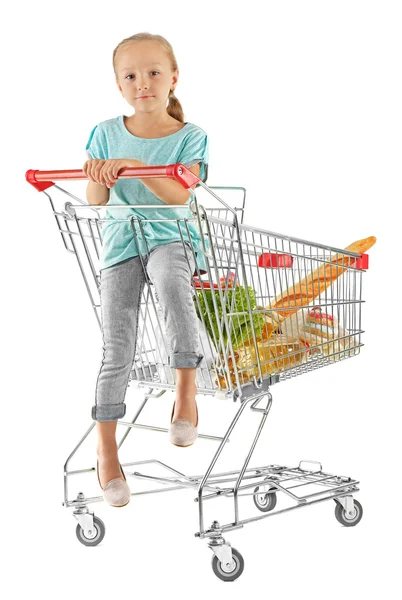 Cute girl sitting in shopping cart — Stock Photo, Image