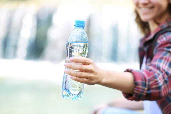 Woman holding bottle — Stock Photo, Image