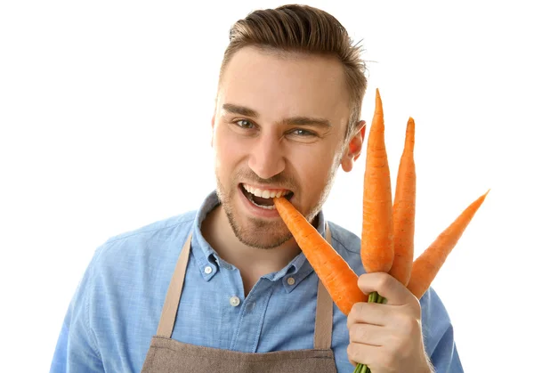 Handsome man eating carrot — Stock Photo, Image