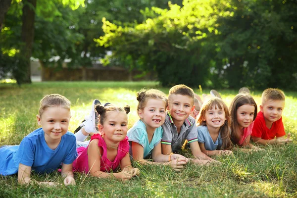 Enfants Heureux Couchés Sur Herbe Dans Parc Photos De Stock Libres De Droits