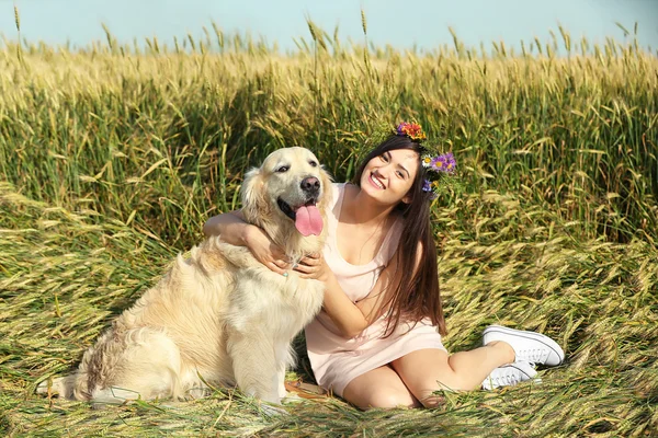 Beautiful girl with cute retriever