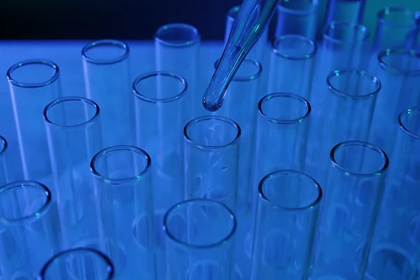 Pipette dropping into test tube — Stock Photo, Image