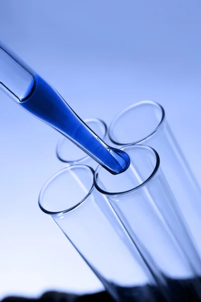 Pipette dropping into test tube — Stock Photo, Image