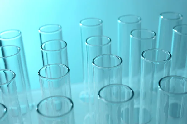 Test tubes on light — Stock Photo, Image