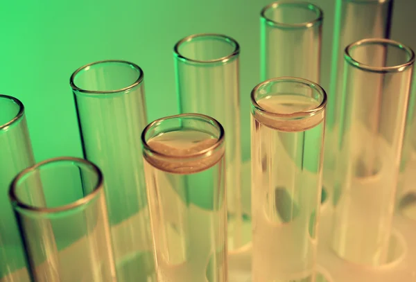 Test tubes on light green — Stock Photo, Image