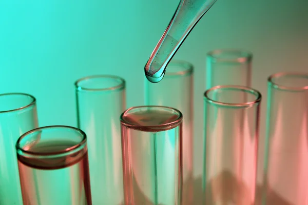 Pipette dropping into test tube — Stock Photo, Image