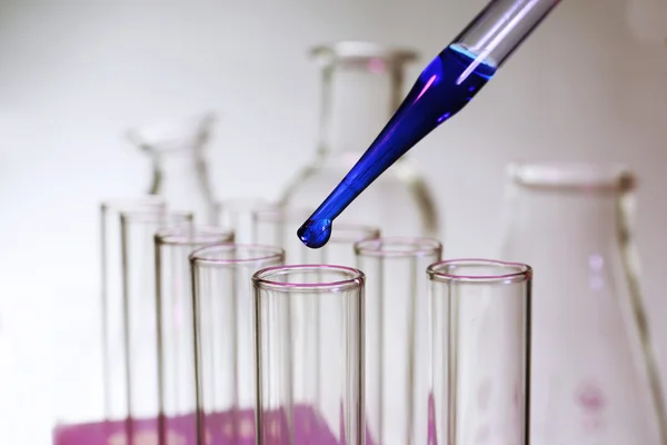 Pipette dropping into test tube — Stock Photo, Image