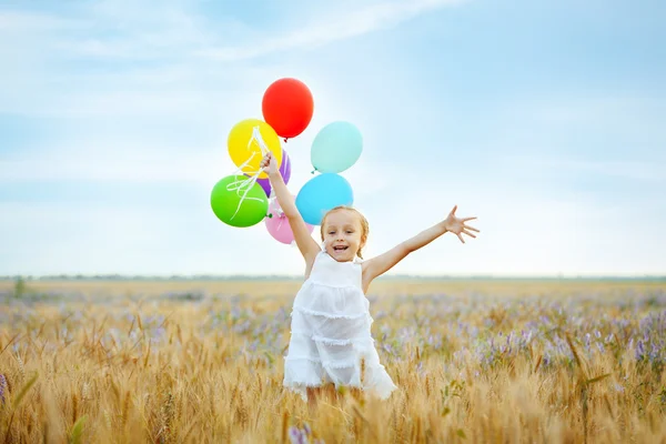 Little girl with balloons — Stock Photo, Image