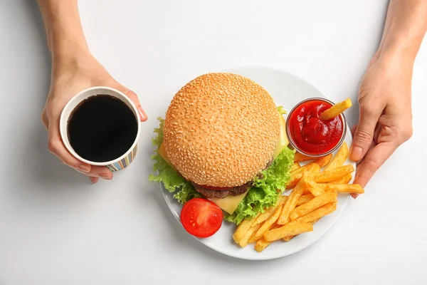 Ženské ruce s hamburger — Stock fotografie