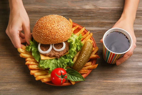 Female hands with hamburger — Stock Photo, Image