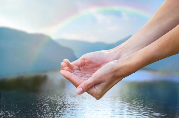 Clear natural water in woman hands — Stock Photo, Image