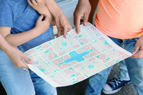 Family looking on map