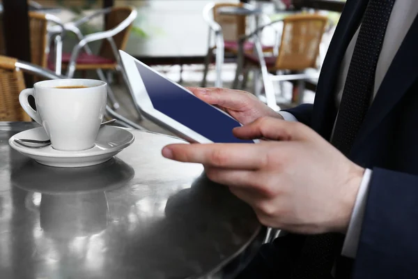 Businessman with coffee and tablet — Stock Photo, Image