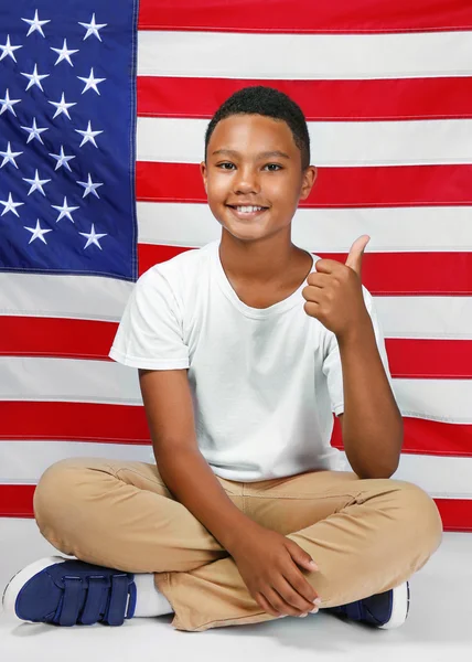 Cute boy on American flag — Stock Photo, Image