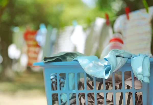 Plastic basket with baby laundry — Stock Photo, Image