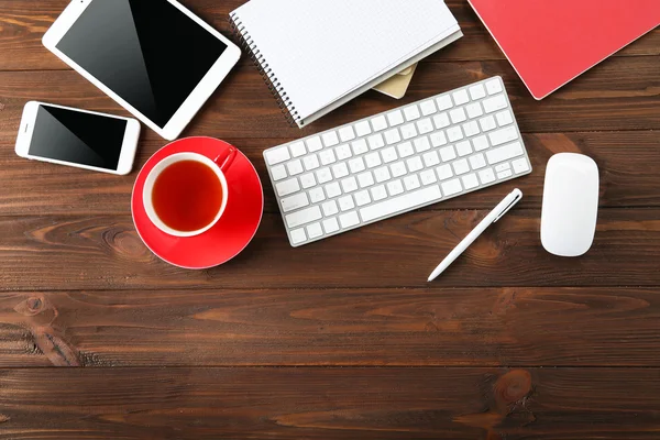 Modern workplace with cup of tea — Stock Photo, Image