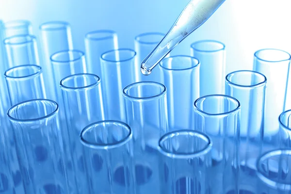 Pipette dropping sample into a test tube — Stock Photo, Image