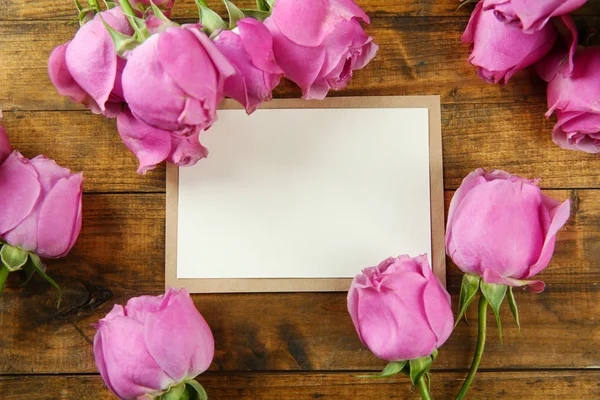 Fresh roses and photo frame — Stock Photo, Image