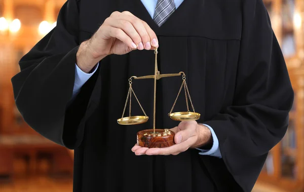 Judge holding scales — Stock Photo, Image