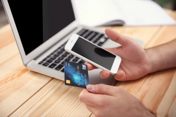 Händer med kreditkort och telefon — Stockfoto