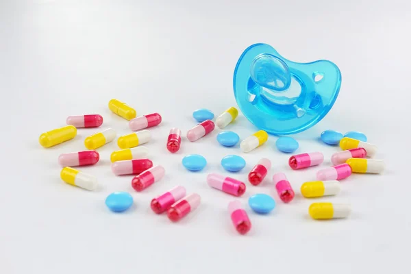 Baby pacifier with pills — Stock Photo, Image