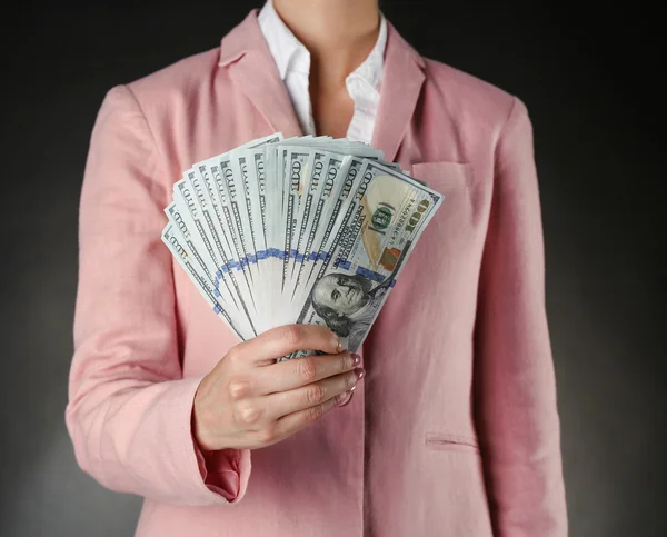 Woman with money on dark — Stock Photo, Image