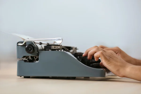 Hombre trabajando en una máquina de escribir retro — Foto de Stock