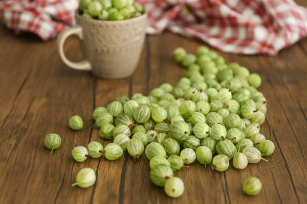 Fresh gooseberries with cup — Stock Photo, Image