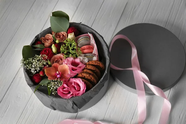 Gift box with flowers and cookies