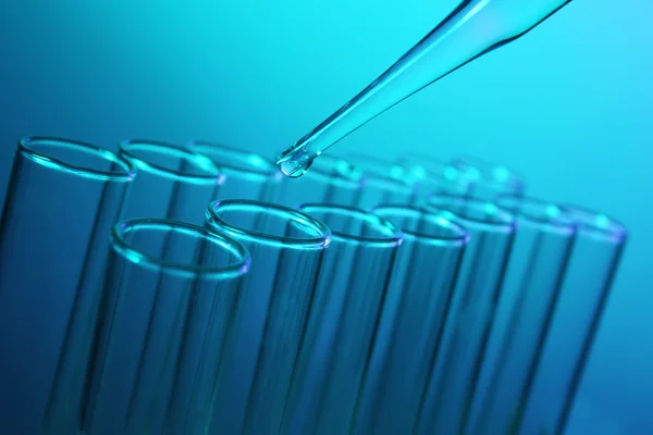 Pipette dropping a  sample into a test tube — Stock Photo, Image