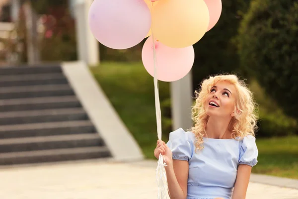 Mujer sosteniendo globos de aire — Foto de Stock