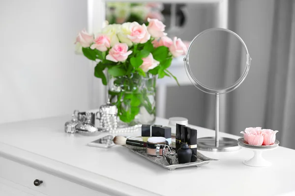 Cosmetic set on light dressing table — Stock Photo, Image