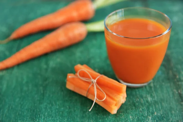 Fresh carrot juice on wooden table — Stock Photo, Image