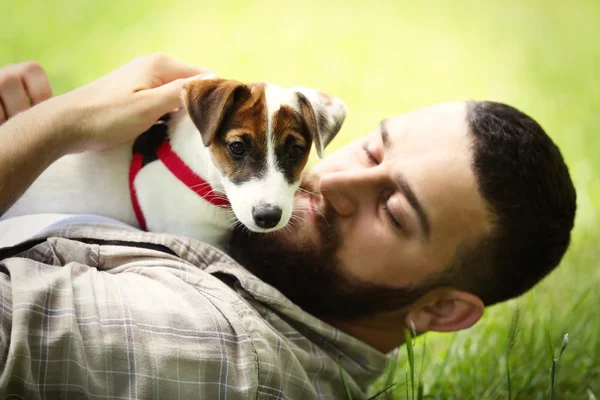 Man with cute dog in spring park — Stock Photo, Image