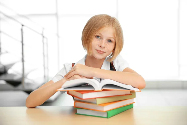 Smiling girl with many books — Stock Photo, Image