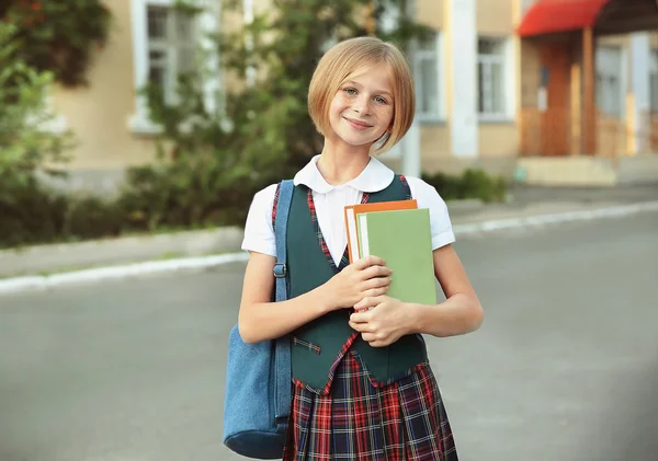 Cute schoolgirl with books — Stock Photo, Image