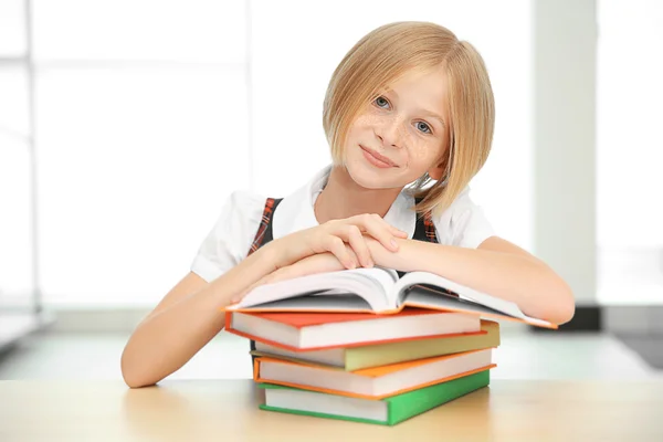 Smiling girl with many books — Stock Photo, Image