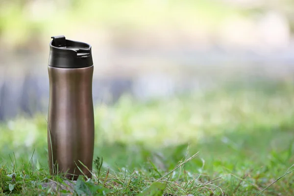 Bottle on a green grass — Stock Photo, Image