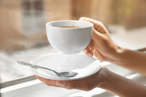 Female hands holding cup of tea — Stock Photo, Image