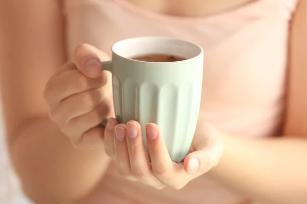 Woman holding cup of tea — Stock Photo, Image